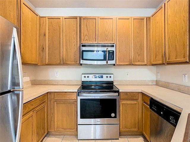 kitchen with light tile patterned floors and appliances with stainless steel finishes