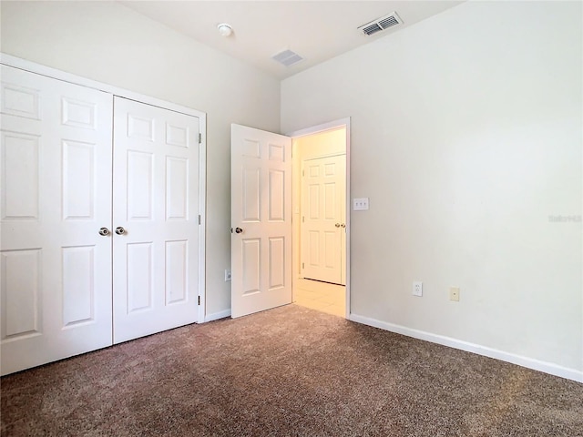 unfurnished bedroom featuring a closet and carpet