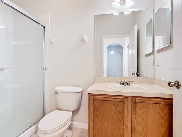 bathroom featuring a shower with door, toilet, tile patterned flooring, and vanity