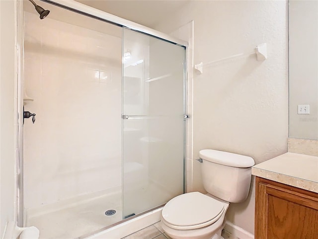 bathroom with vanity, toilet, and an enclosed shower