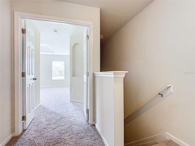 hall featuring light colored carpet