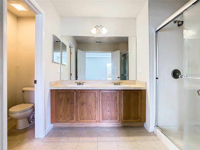 bathroom featuring a shower with door, toilet, tile patterned flooring, and vanity