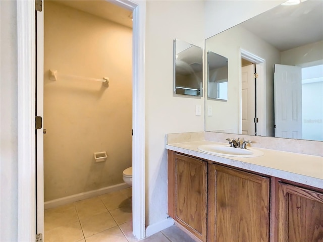 bathroom featuring toilet, tile patterned flooring, and vanity