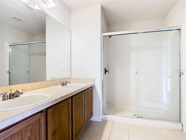 bathroom with vanity, an enclosed shower, and tile patterned flooring