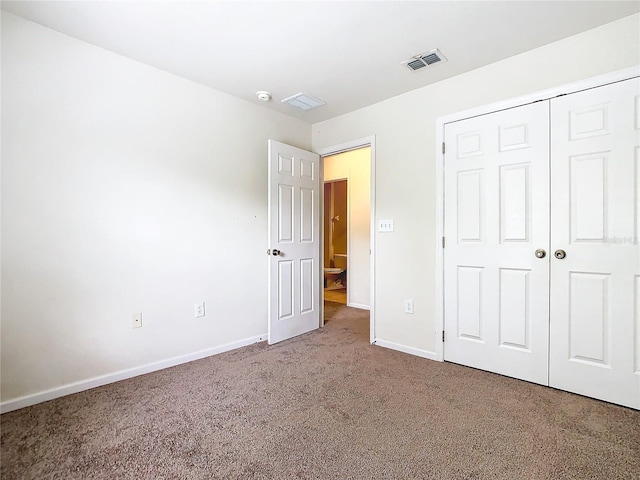 unfurnished bedroom featuring a closet and carpet floors