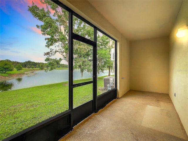 unfurnished sunroom with a water view