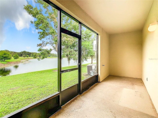 unfurnished sunroom featuring a water view