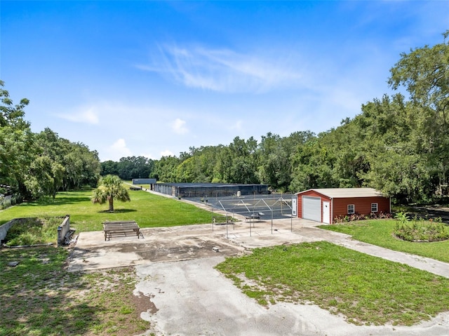 view of property's community featuring a yard and an outbuilding