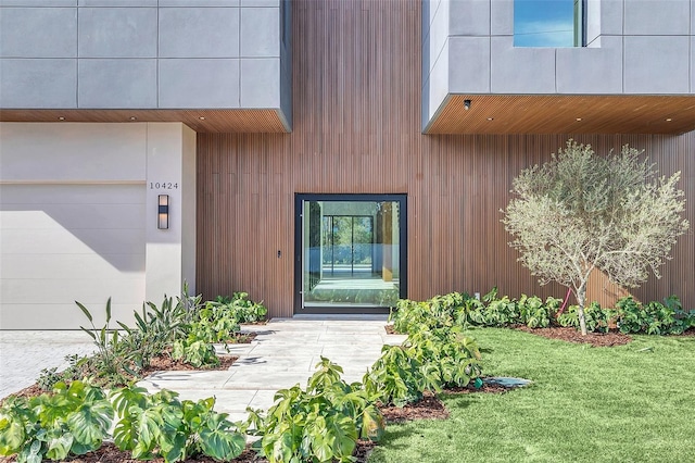 doorway to property featuring a lawn