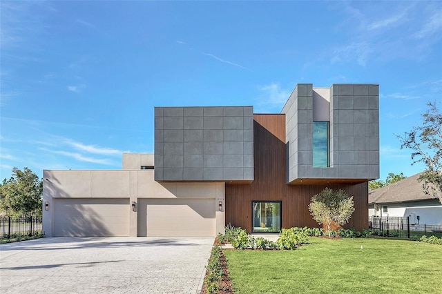 modern home with a garage and a front lawn