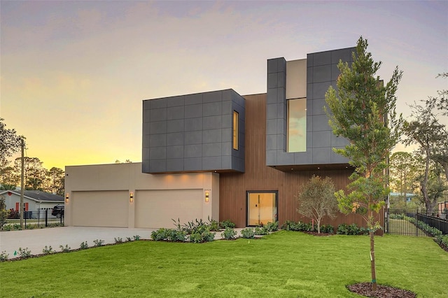 contemporary house with a yard and a garage