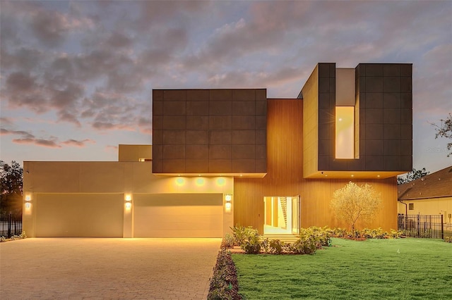 contemporary home featuring a yard and a garage