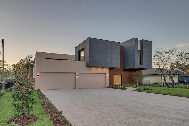 contemporary house with a garage and a lawn