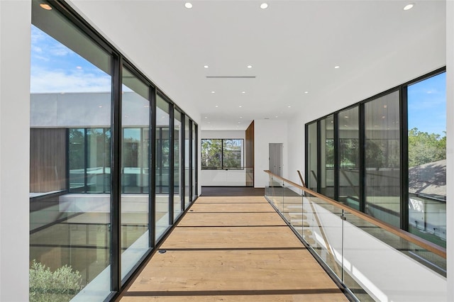 hallway with hardwood / wood-style flooring