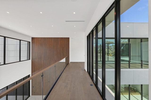 corridor with light hardwood / wood-style flooring