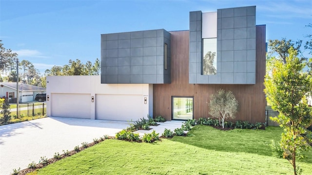 contemporary home with a front yard and a garage