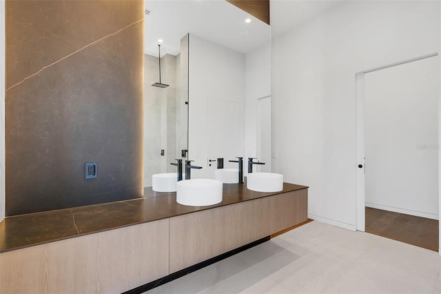 bathroom with a shower and vanity