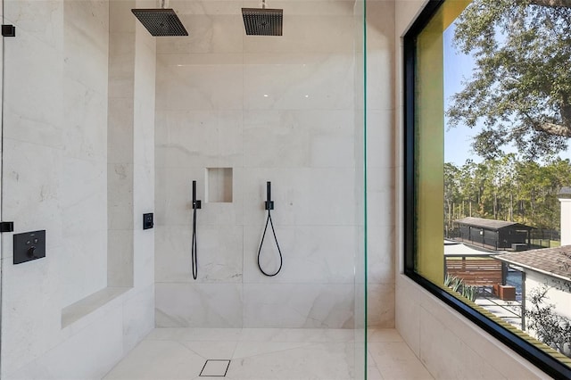 bathroom with a tile shower