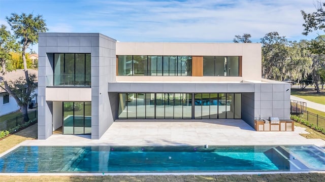 back of house with a fenced in pool