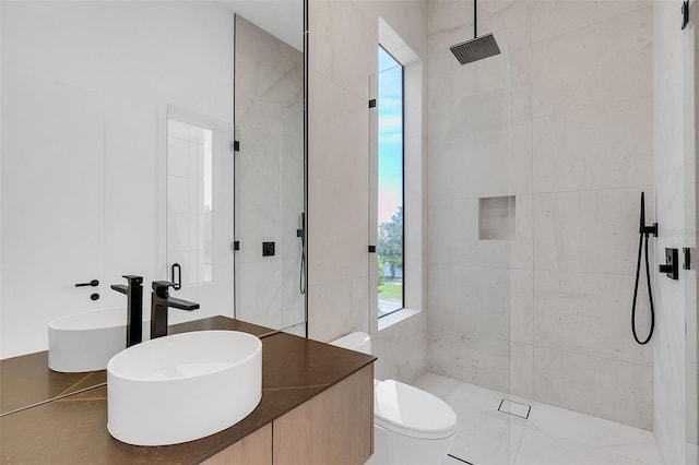 bathroom with sink, an enclosed shower, and toilet