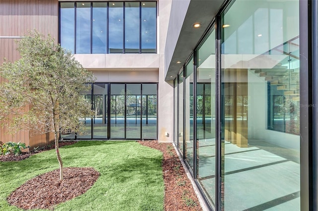 doorway to property featuring a lawn