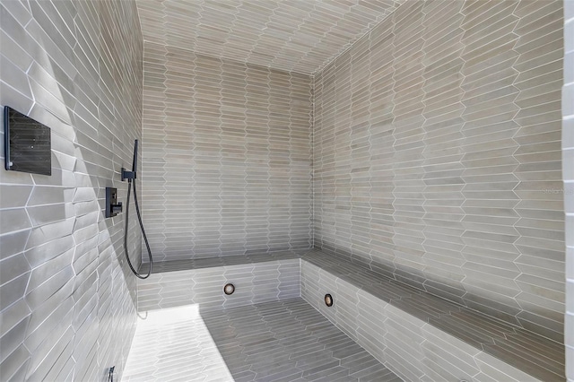 bathroom with a tile shower