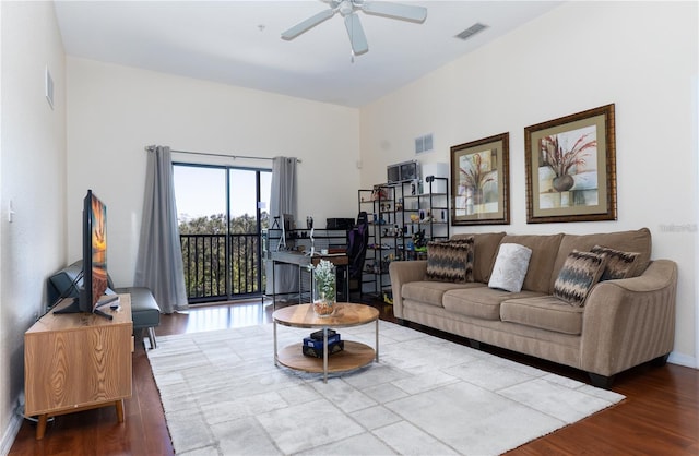 living room with ceiling fan and wood-type flooring