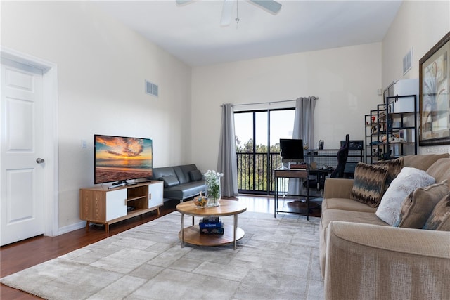 living room featuring ceiling fan and hardwood / wood-style flooring