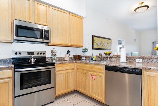 kitchen with light brown cabinetry, sink, and stainless steel appliances