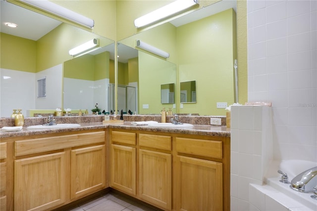 bathroom featuring tile patterned floors, vanity, and independent shower and bath