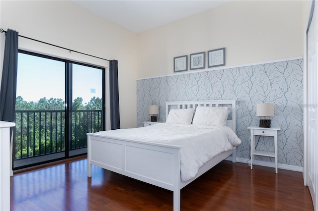 bedroom featuring dark hardwood / wood-style floors and access to outside