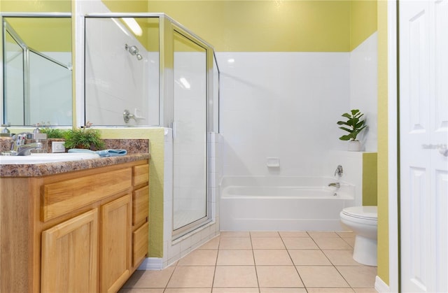 bathroom featuring tile patterned flooring, vanity, toilet, and an enclosed shower