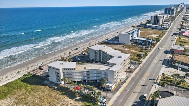 bird's eye view with a water view and a beach view