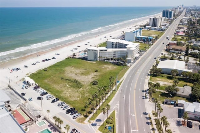 birds eye view of property featuring a water view and a beach view