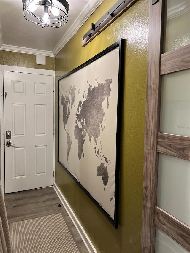 interior space with hardwood / wood-style floors and crown molding