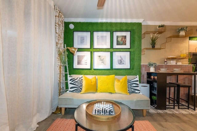 sitting room featuring hardwood / wood-style flooring and crown molding