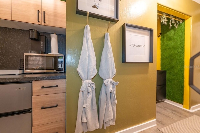 bathroom with light hardwood / wood-style flooring