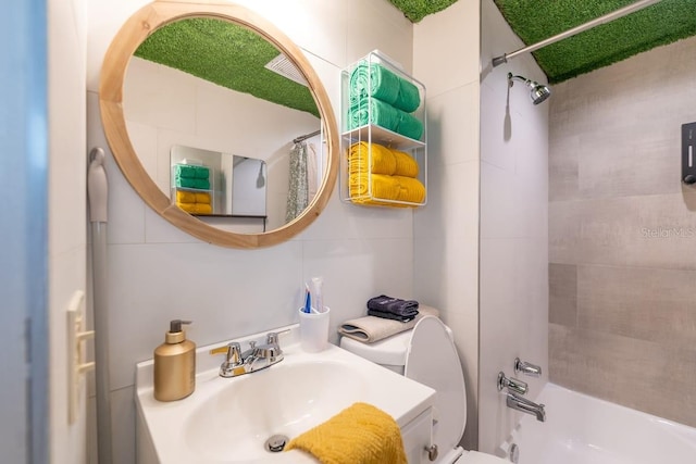 full bathroom featuring tile walls, sink, toilet, and shower / bath combo with shower curtain