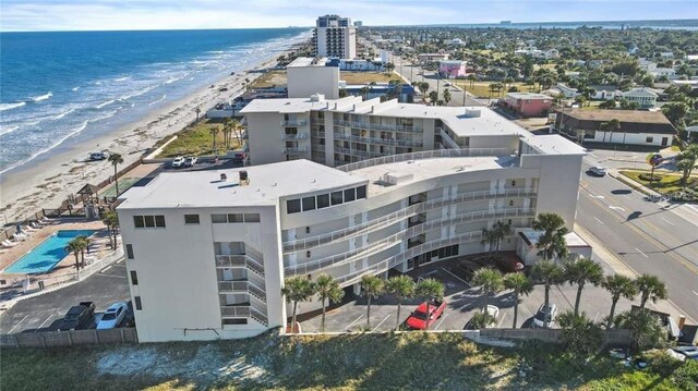 aerial view featuring a water view and a beach view