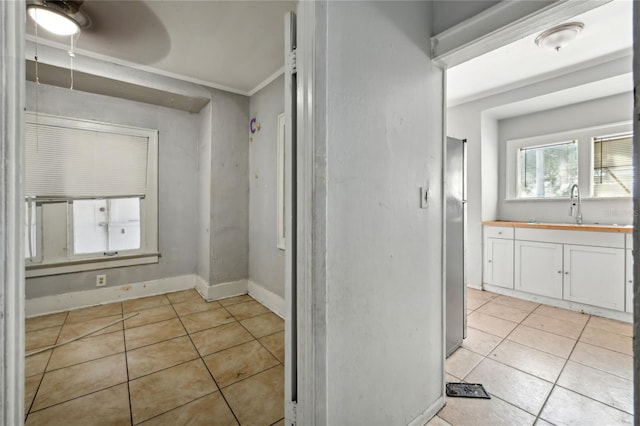 bathroom with crown molding, sink, and tile patterned floors