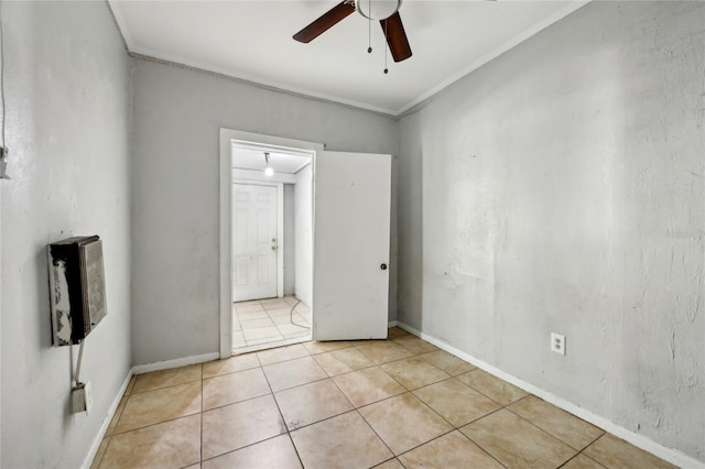 unfurnished room featuring crown molding, ceiling fan, and light tile patterned floors