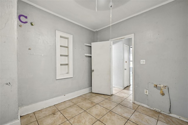 unfurnished room featuring crown molding and light tile patterned flooring