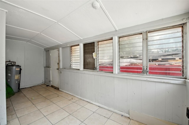 interior space featuring vaulted ceiling and water heater