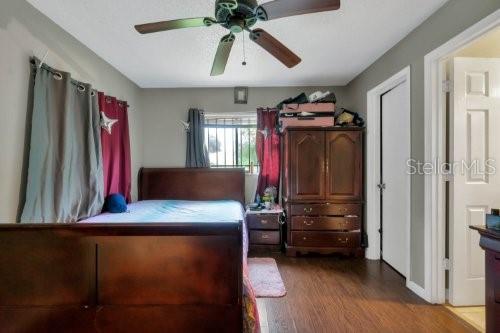 bedroom with hardwood / wood-style flooring and ceiling fan