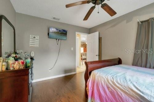 bedroom featuring dark wood-type flooring and ceiling fan