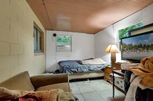 bedroom featuring wood ceiling and cooling unit