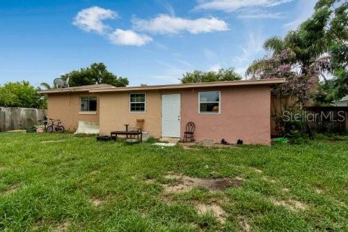 rear view of house with a lawn