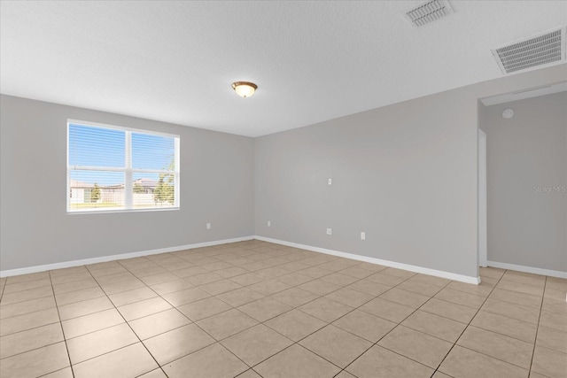 unfurnished room featuring visible vents and baseboards