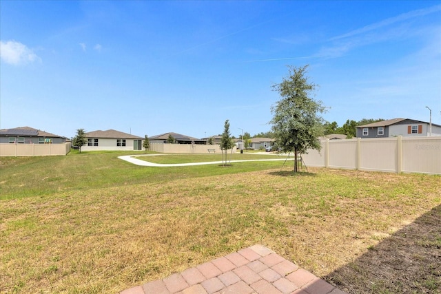 view of yard featuring fence and a residential view