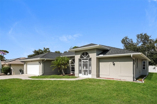 view of front of property with a garage and a front lawn